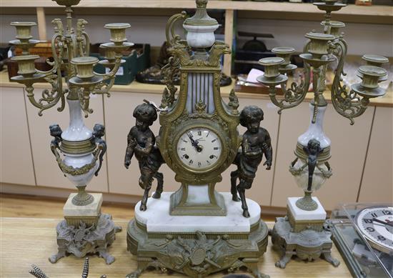 A gilt metal and marble clock garniture, mounted with cherubs height 61cm
